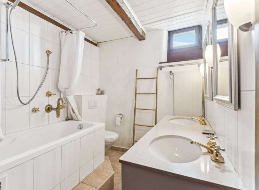 This charming bathroom features a classic design with a touch of rustic elegance.
