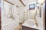 This charming bathroom features a classic design with a touch of rustic elegance.