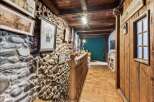 Step into a unique property with this stunning hallway, featuring a rustic stone wall and wooden accents.