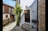 Discover the charm of this historic property, featuring a beautifully crafted wooden door and stone steps.