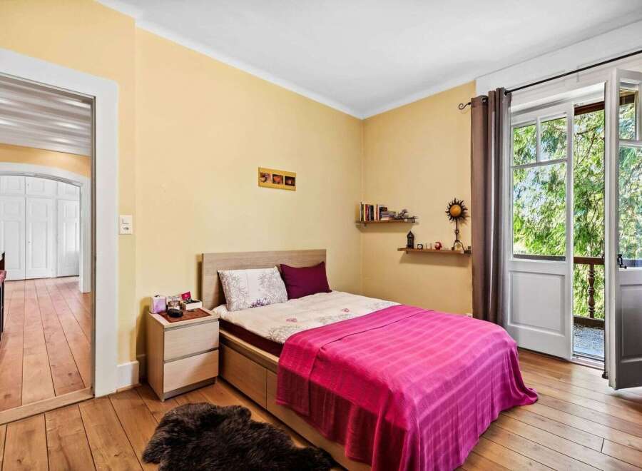 This charming bedroom offers a cozy retreat with its warm color palette and inviting ambiance.