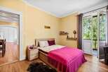 This charming bedroom offers a cozy retreat with its warm color palette and inviting ambiance.