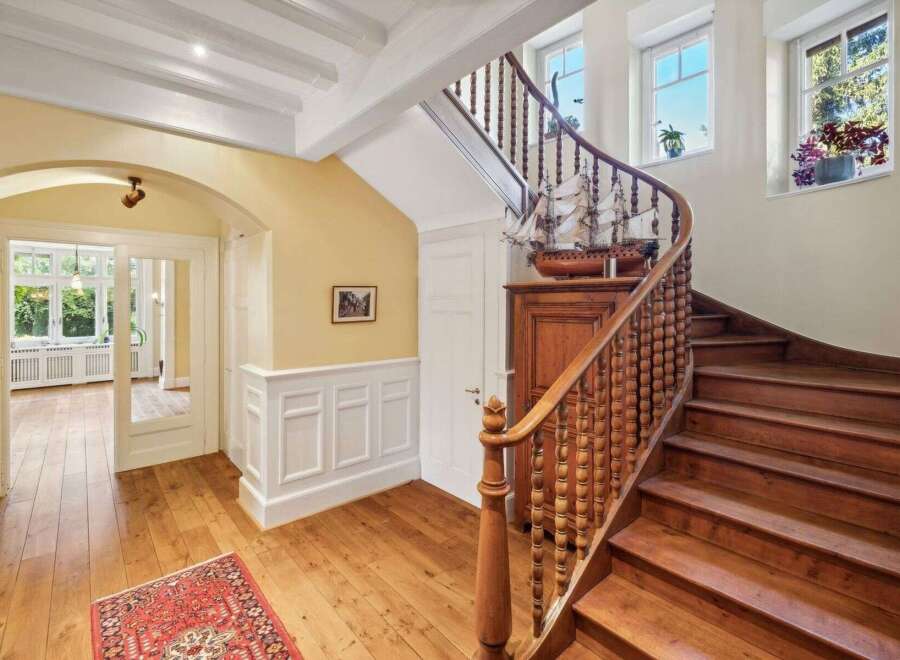 Step into elegance with this stunning property featuring a grand staircase and beautiful hardwood floors.