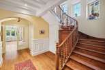 Step into elegance with this stunning property featuring a grand staircase and beautiful hardwood floors.