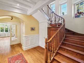 Step into elegance with this stunning property featuring a grand staircase and beautiful hardwood floors.