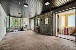 This spacious room boasts a unique blend of rustic and modern design elements, perfect for a variety of uses.