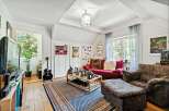 This cozy living space features a vibrant red sofa, perfect for relaxing.