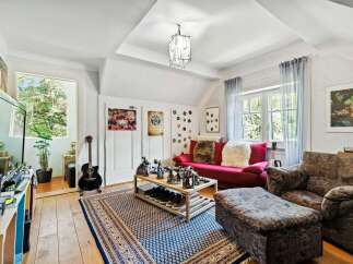 This cozy living space features a vibrant red sofa, perfect for relaxing.