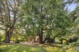 Discover the charm of this stunning property, nestled amidst lush greenery and mature trees.