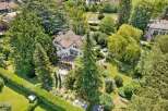 Discover this stunning property nestled in a serene, tree-filled setting.