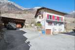 Nestled in a picturesque mountain setting, this charming property boasts a beautiful facade with vibrant red shutters.