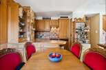 This charming kitchen boasts beautiful wooden cabinetry and a cozy dining area.