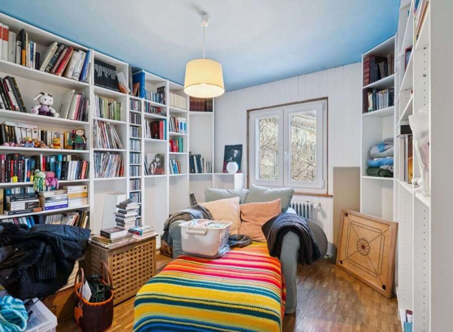 Discover a cozy reading nook in this charming home, complete with built-in bookshelves and a comfortable seating area.