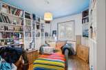 Discover a cozy reading nook in this charming home, complete with built-in bookshelves and a comfortable seating area.