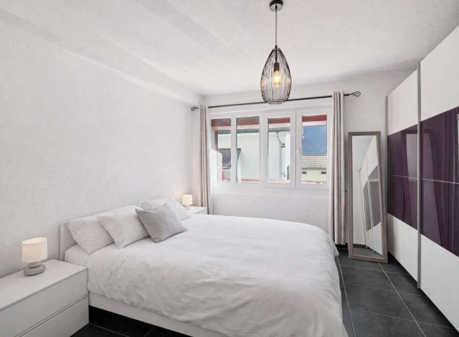 This bright and airy bedroom offers a serene retreat.