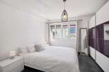 This bright and airy bedroom offers a serene retreat.