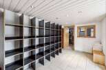 Discover the potential of this versatile space! This property boasts a unique storage solution with built-in shelving, perfect for organization.