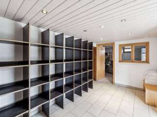 Discover the potential of this versatile space! This property boasts a unique storage solution with built-in shelving, perfect for organization.