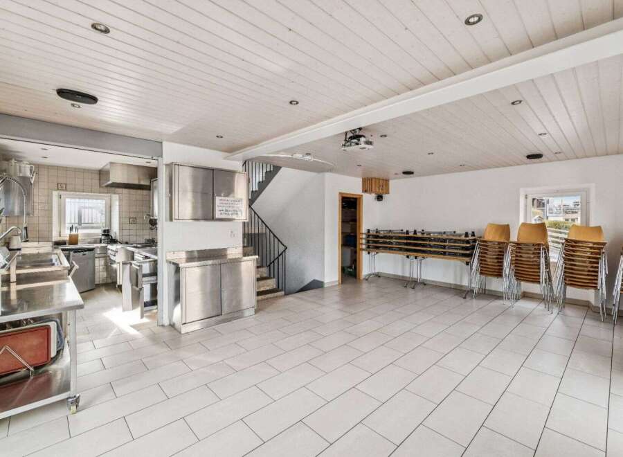 This spacious property features a well-equipped commercial kitchen, perfect for culinary ventures.
