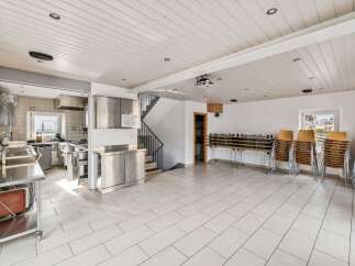This spacious property features a well-equipped commercial kitchen, perfect for culinary ventures.