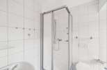 Step into this bright and airy bathroom featuring a modern glass shower enclosure.