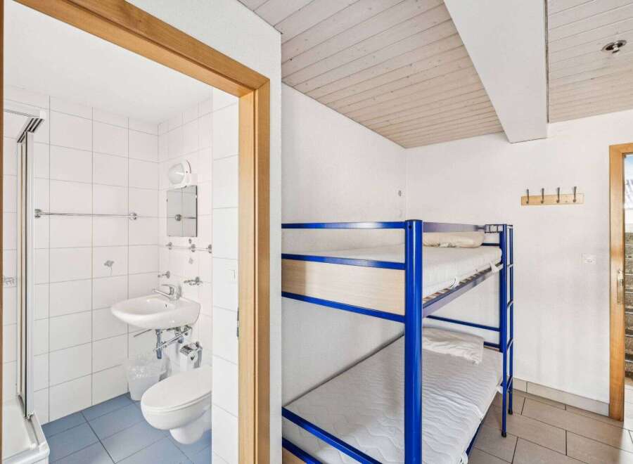 Discover this charming property featuring a cozy bunk bed setup, perfect for accommodating guests or family.