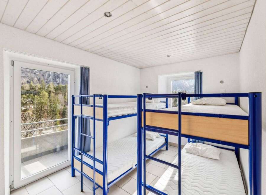 This cozy hostel room features multiple bunk beds, perfect for accommodating groups or budget travelers.