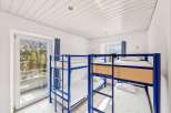 This cozy hostel room features multiple bunk beds, perfect for accommodating groups or budget travelers.