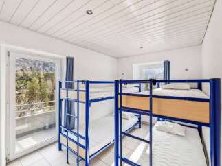 This cozy hostel room features multiple bunk beds, perfect for accommodating groups or budget travelers.