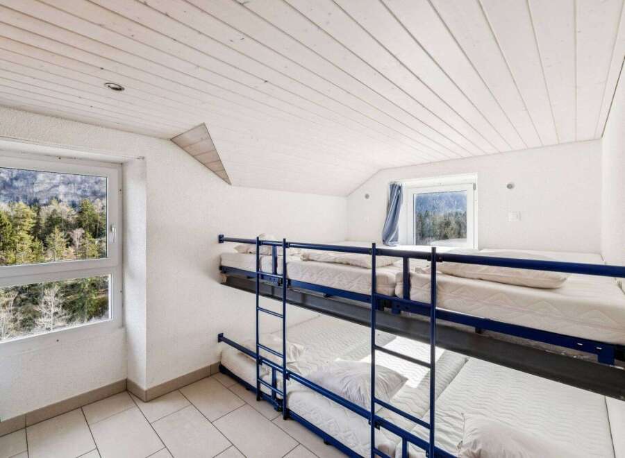Discover the charm of this cozy bunk room, perfect for accommodating guests or family.