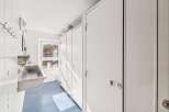 This well-maintained restroom features clean white walls and a bright blue tiled floor, creating a fresh and inviting atmosphere.