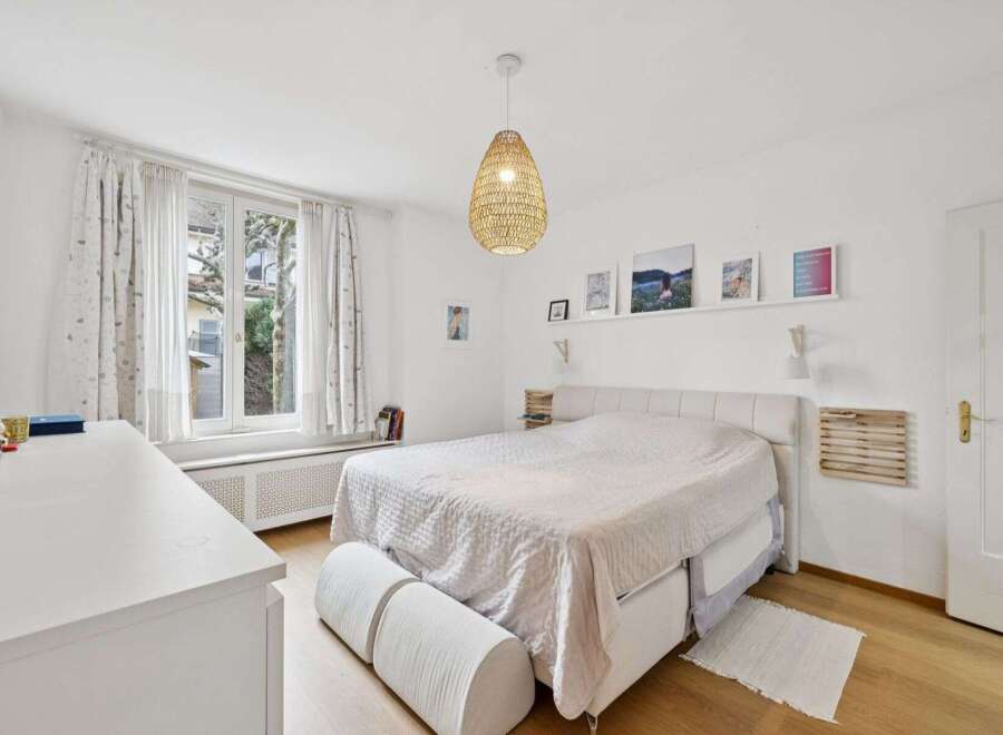 This bright and airy bedroom offers a serene retreat.