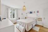 This bright and airy bedroom offers a serene retreat.