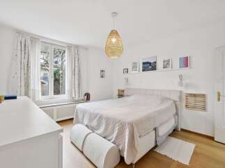 This bright and airy bedroom offers a serene retreat.