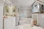 Step into a serene bathroom retreat, featuring a classic design with a touch of elegance.