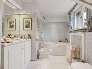 Step into a serene bathroom retreat, featuring a classic design with a touch of elegance.