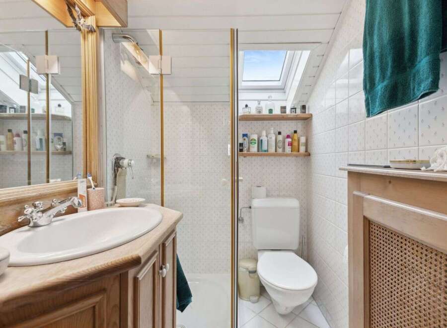 Step into this charming bathroom, featuring a bright and airy design.