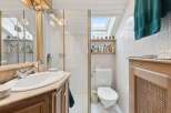 Step into this charming bathroom, featuring a bright and airy design.