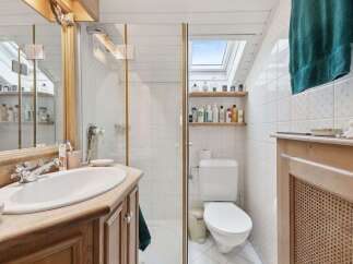Step into this charming bathroom, featuring a bright and airy design.