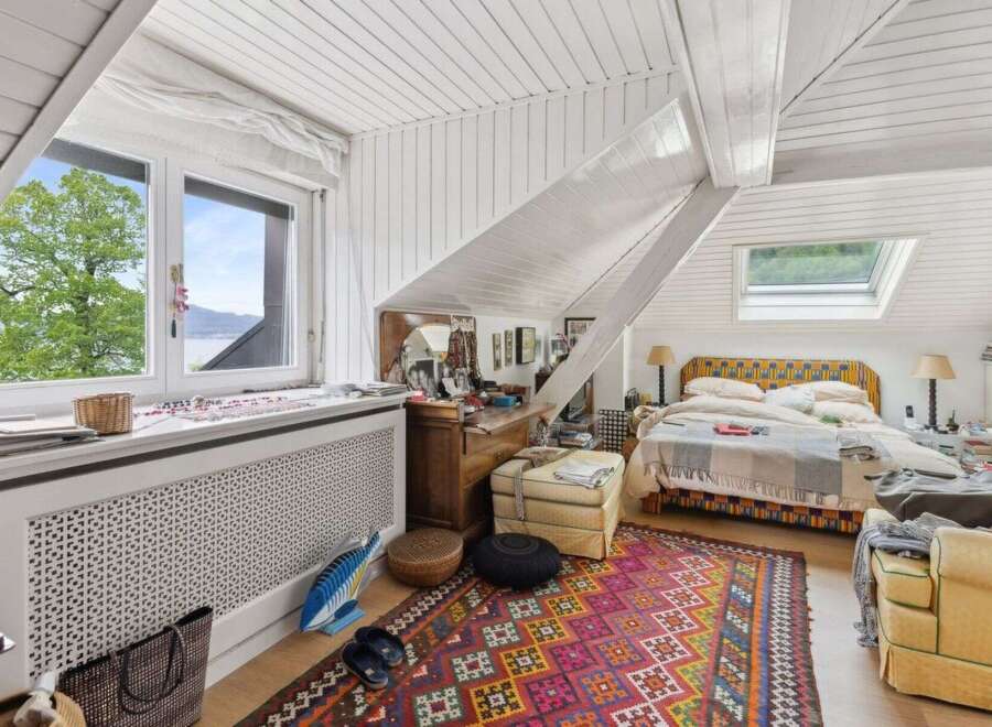 This charming bedroom features a unique sloped ceiling and a cozy atmosphere.