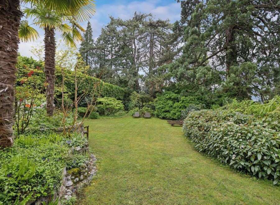 Discover the tranquility of this stunning property, featuring a lush, expansive lawn perfect for relaxation and outdoor activities.