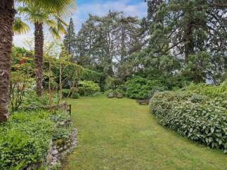 Discover the tranquility of this stunning property, featuring a lush, expansive lawn perfect for relaxation and outdoor activities.