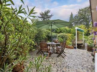 Enjoy outdoor living at its finest with this charming patio space.