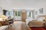 Discover the charm of this inviting bedroom, featuring a blend of natural light and elegant design.
