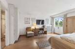 This bright and airy bedroom offers a comfortable and stylish living space.
