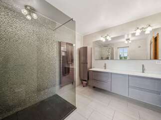 Step into luxury with this stunning bathroom featuring a sleek, modern design.
