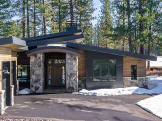 This stunning modern home seamlessly blends with its natural surroundings, offering a tranquil retreat.