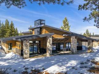 This stunning modern home boasts a unique architectural design with a blend of natural materials.