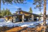 This stunning modern home boasts a striking exterior with a combination of wood and stone accents.