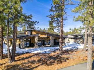 This stunning modern home boasts a unique architectural design with a blend of natural materials.